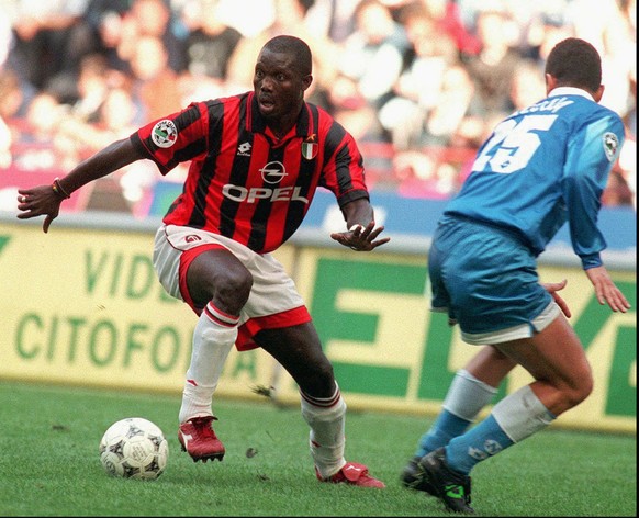 Milan&#039;s forward George Weah, left, dribbles past Napoli defender Mirko Taccola during their Italian major league match in Milan Sunday, October 20, 1996. Weah scored first two goals in Milan&#039 ...
