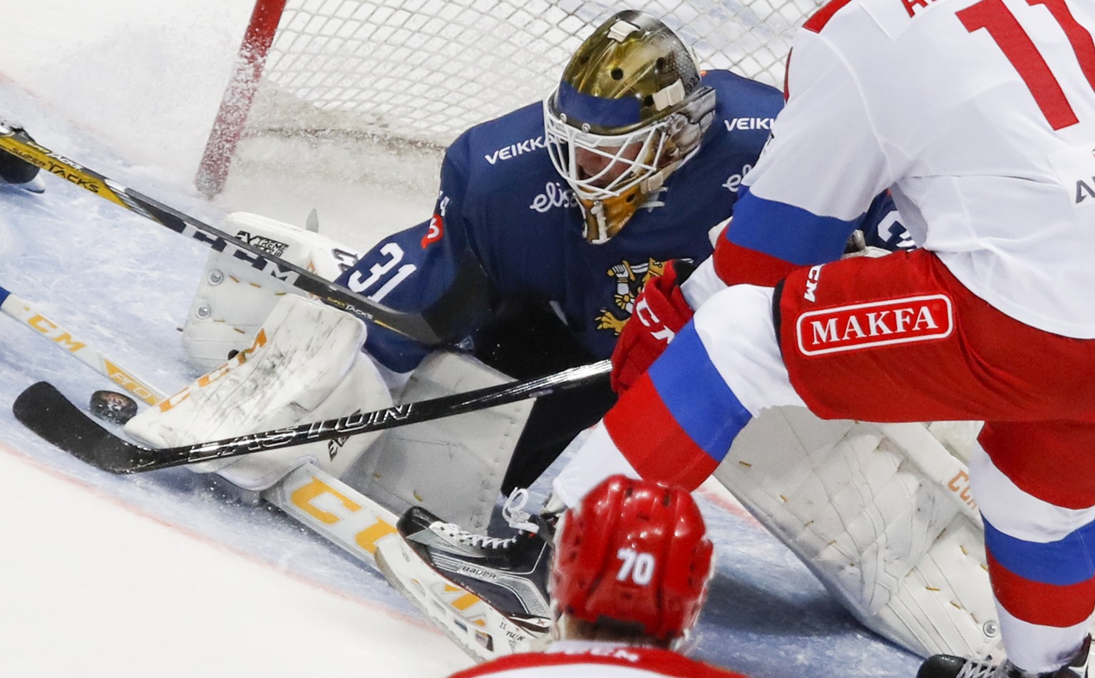 Russia&#039;s Sergei Andronov, right, tries to score as Finland&#039;s goalie Joni Ortio makes a save during the Ice Hockey Channel One Cup match between Russia and Finland in Moscow, Russia, Sunday,  ...