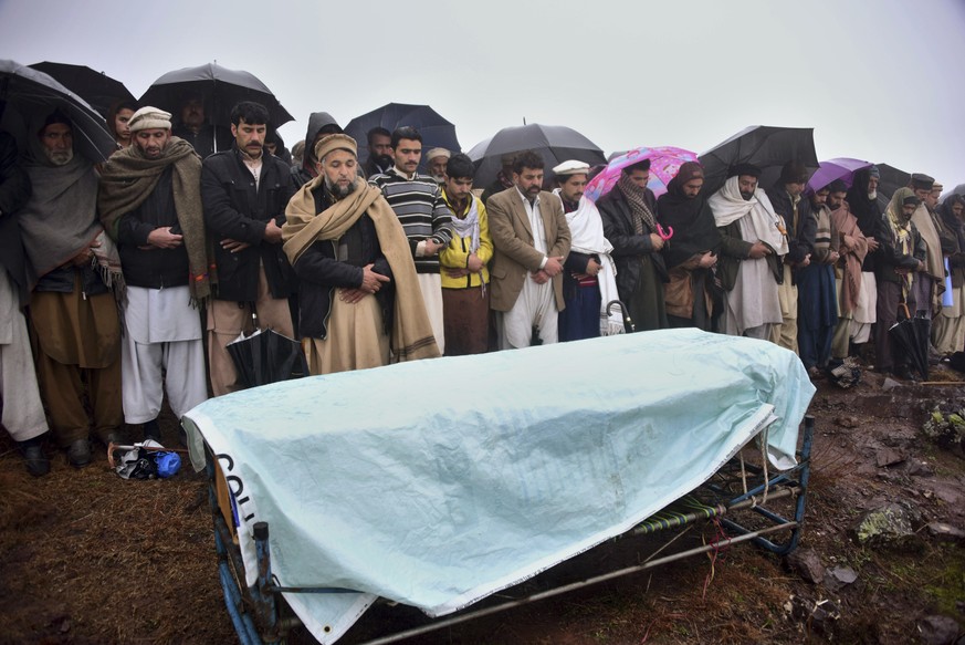 Villagers carry offering funeral prayer of a boy, who was killed by Indian shelling, at a village in Hatian Bala, 40 kilometers from Muzafarabad, capital of Pakistani Kashmir, Saturday, March 2, 2019. ...