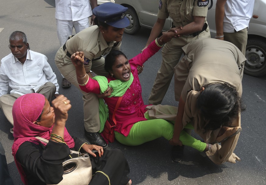 Indian policewomen detain members of Communist Party of India (CPI) protesting against the visit of U.S. President Donald Trump to India, in Hyderabad, India, Tuesday, Feb. 25, 2020. President Donald  ...