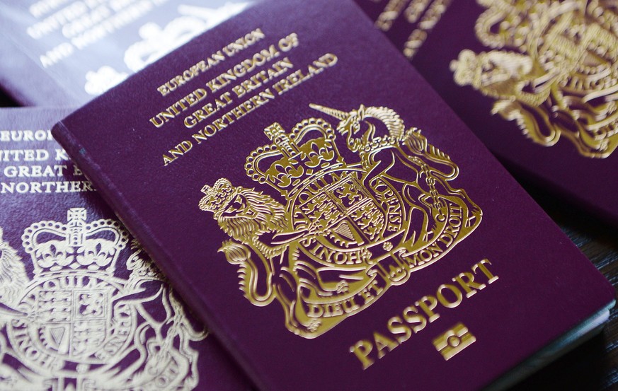 epa04253525 British passports in London, Britain, 13 June 2014. The Home Office has said on 12 July that to help clear the huge backlog of passport applications it will scrap charges for urgent renewa ...