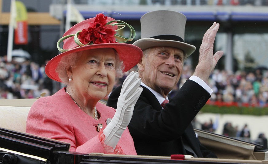 FILE - In this Thursday, June, 16, 2011 file photo Britain&#039;s Queen Elizabeth II with Prince Philip arrive by horse drawn carriage in the parade ring on the third day, traditionally known as Ladie ...