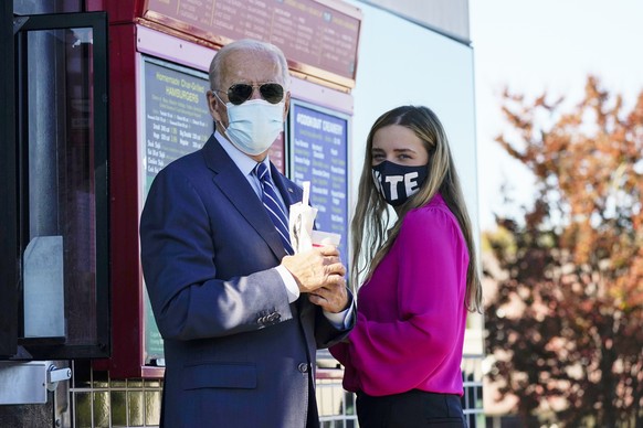 Democratic presidential candidate former Vice President Joe Biden and his granddaughter Finnegan, stand and talk after ordering at the window at Cook Out in Durham, N.C., Sunday, Oct. 18, 2020. (AP Ph ...