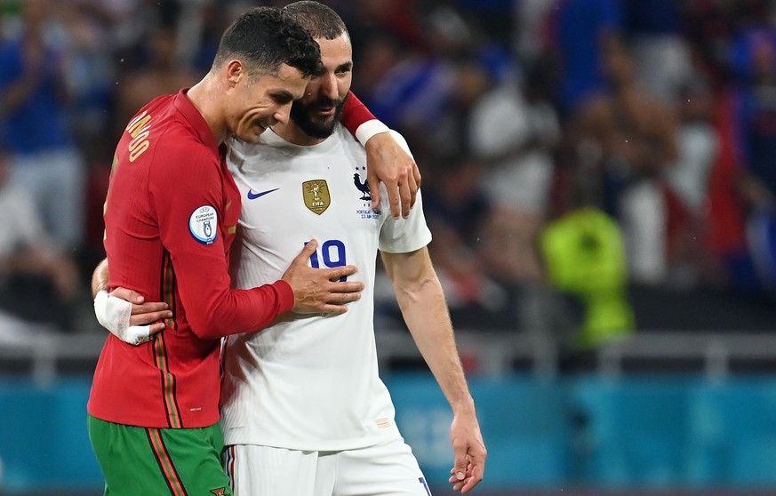 epa09297018 Karim Benzema of France (R) reacts with Cristiano Ronaldo of Portugal during the UEFA EURO 2020 group F preliminary round soccer match between Portugal and France in Budapest, Hungary, 23  ...