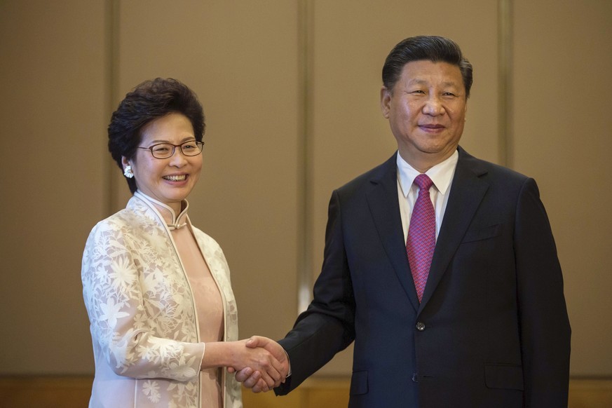 CORRECTS TITLE OF LAM - Chinese President Xi Jinping poses with Hong Kong&#039;s Chief Executive Carrie Lam ahead of a meeting in Hong Kong, Saturday, July 1, 2017. (Billy H.C. Kwok/Pool Photo via AP)