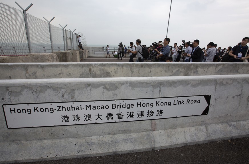 epa07104203 Members of the media stand at the Hong Kong-China border on the Hong Kong Zhuhai Macau Bridge in Hong Kong, China, 19 October 2018. The bridge opening ceremony will be on 23 October 2018,  ...
