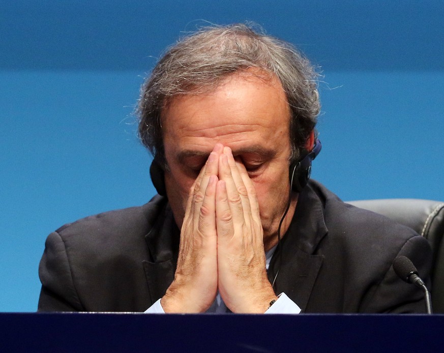 FILE - In this March 24, 2015 file photo UEFA President Michel Platini covers his face during a news conference at the end of the 39th Ordinary UEFA Congress in Vienna, Austria. The Court of Arbitrati ...