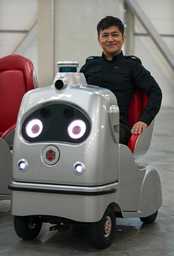 epa08612028 Hisashi Taniguchi, Chief Executive Officer of Japan&#039;s robotic technology company ZMP Inc., sits on autonomous driving electric wheelchair RakuRo, which was developed by ZMP, at the co ...
