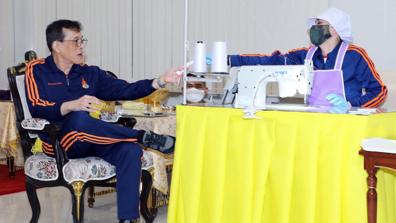 epa08395092 An undated handout photo made available by the Thai Royal Household Bureau shows Thai King Maha Vajiralongkorn Bodindradebayavarangkun (L) receiving face mask embroidered by Thai Queen Sut ...