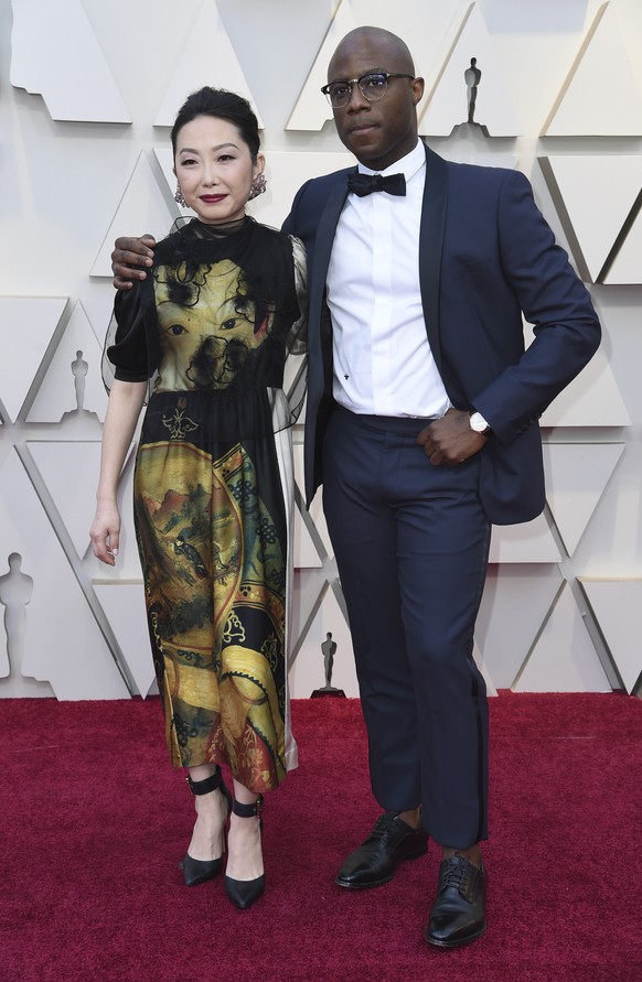 Lulu Wang, left, and Barry Jenkins arrive at the Oscars on Sunday, Feb. 24, 2019, at the Dolby Theatre in Los Angeles. (Photo by Richard Shotwell/Invision/AP)