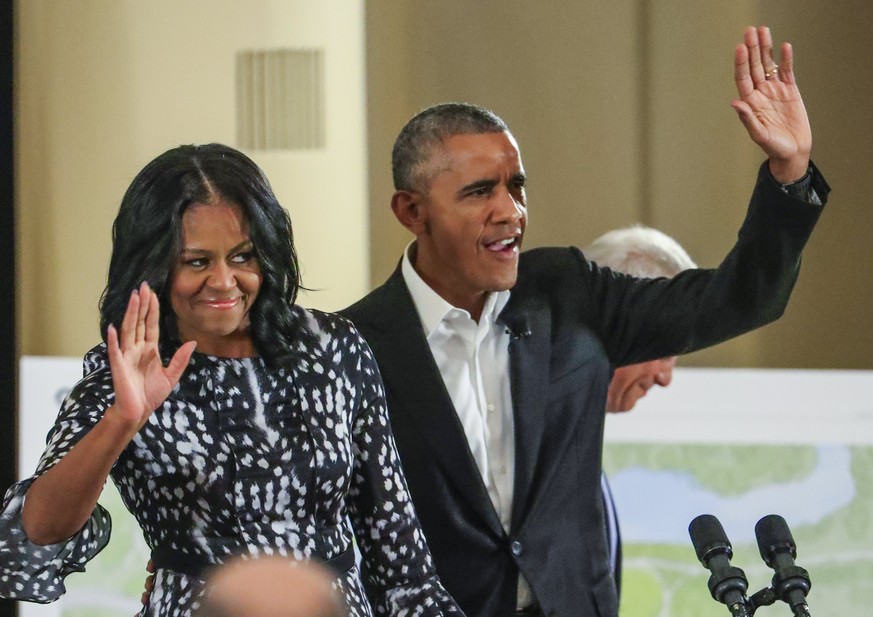 epa05942434 Former US President Barack Obama (R) and former US First Lady Michelle Obama (L) wave as they arrive to participate in a roundtable discussion and community meeting on the Obama Presidenti ...