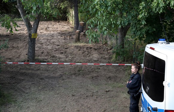 epa08573011 A policewoman stands guard at the operation site, after police search in a garden plot in Hannover, northern Germany, 29 July 2020. Police is working on the site in relation to the investi ...