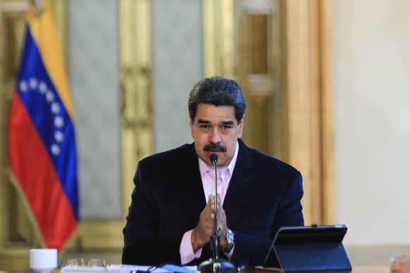 epa08325638 A handout photo made available by Miraflores Press shows President of Venezuela Nicolas Maduro speaking during the Presidential Commission meeting for the prevention of Covid-19 at the Mir ...