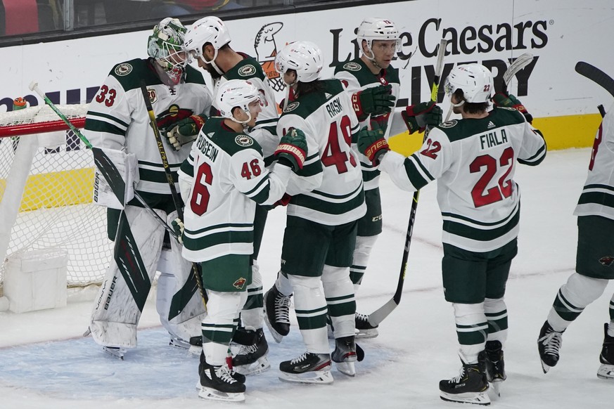Minnesota Wild players celebrate after defeating the Vegas Golden Knights in an NHL hockey game Monday, May 24, 2021, in Las Vegas. (AP Photo/John Locher)