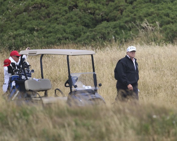 FILE - In the Saturday, July 14, 2018 file photo, President Donald Trump plays golf at Turnberry golf club, Scotland. Trump’s alleged misdeeds on and around the golf course are the subject of a new bo ...