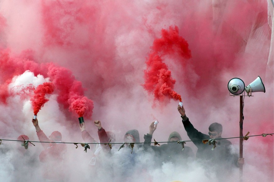 epa00941103 Red Star Belgrade fans hold flares during their derby soccer match with Partizan Belgrade in Belgrade in Belgrade, on Saturday 24 February 2007. The Derby between Red Star and Partizan is  ...