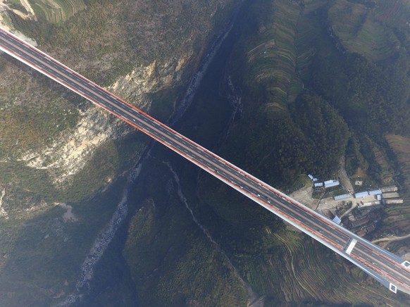 epa05693751 A picture made available on 01 January 2017 shows an aerial view of Beipanjiang Bridge in Shuicheng county, Guizhou province, China, 31 December 2016, on its first day opening to traffic.  ...