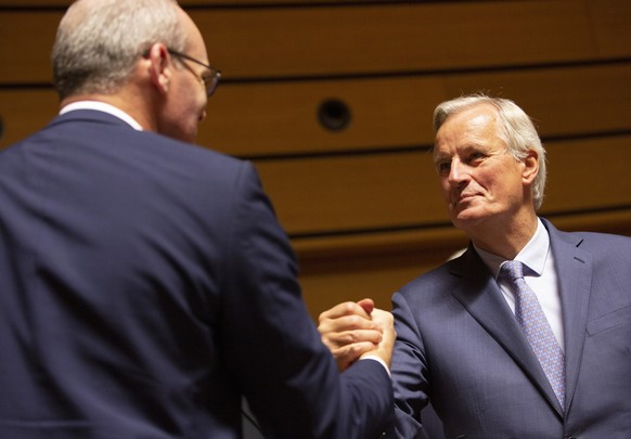 European Union chief Brexit negotiator Michel Barnier, right, greets Irish Foreign Minister Simon Coveney during a meeting of EU General Affairs ministers, Article 50, at the European Convention Cente ...