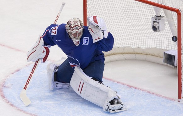 Team France goalie Cristobal Huet fails to stop a puck as Team Canada Brayden Schenn scores the first goal during first period action Friday, May 9, 2014 at the IIHF World Hockey Championship in Minsk ...