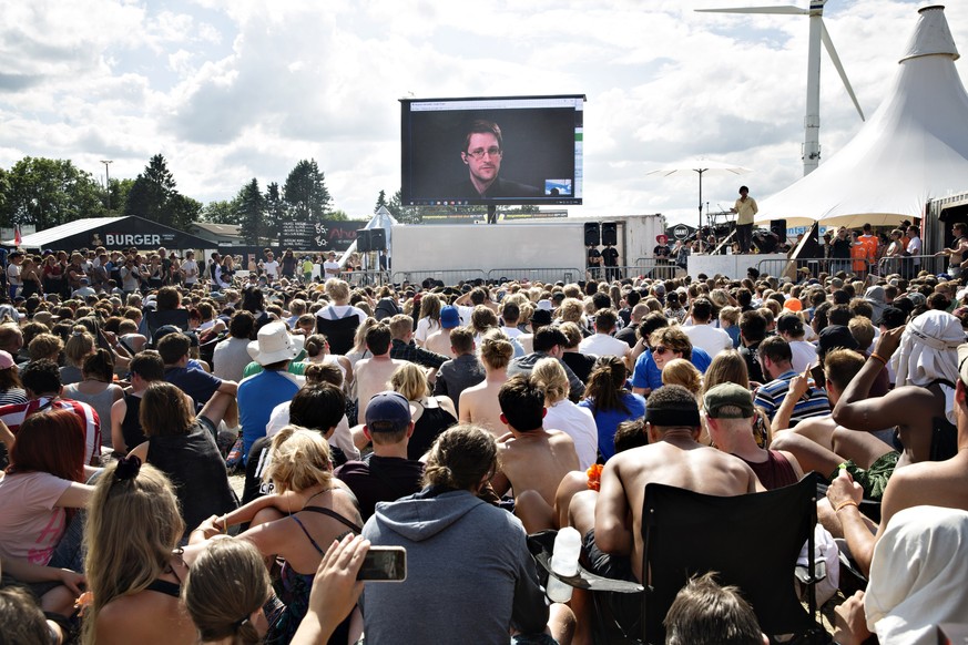 Whistleblower Edward Snowden of the US, speaks to the crowd on a gigant screen at the Roskilde Festival in Roskilde, Denmark, Tuesday, June 28. 2016. &quot;You are being watched all the time and you h ...