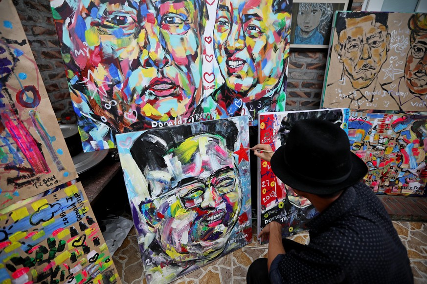 epa07384528 Vietnamese artist Tran Lam Binh applies finishing touches to his portrait of North Korean leader Kim Jong-un at a cafe in Hanoi, Vietnam, 21 February 2019, a week before the second summit  ...