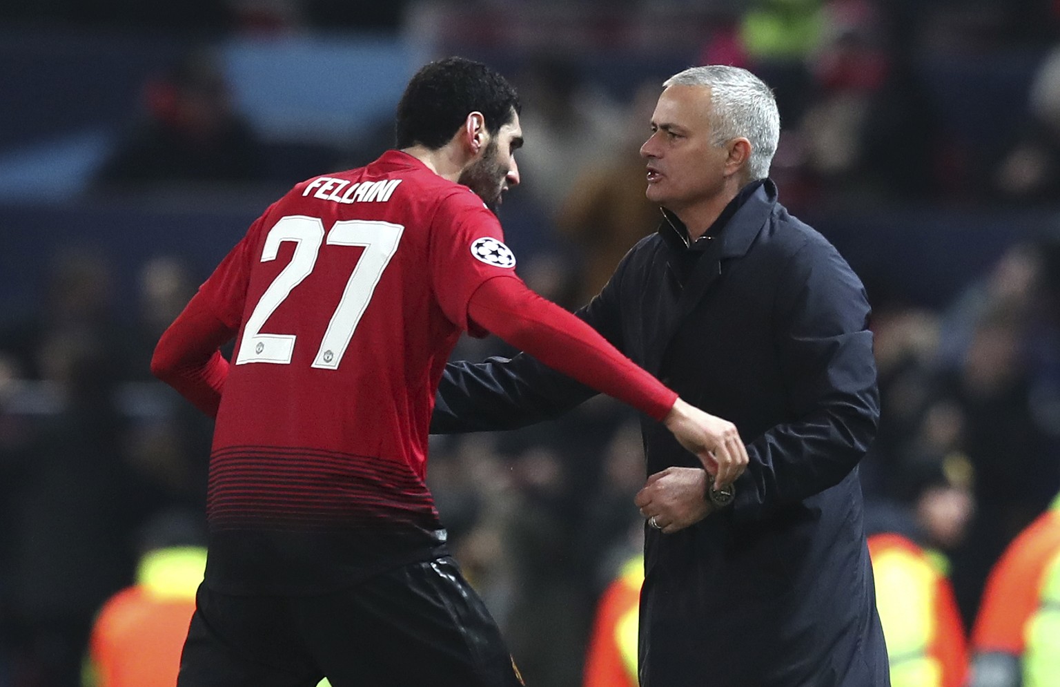 ManU midfielder Marouane Fellaini celebrates with ManU coach Jose Mourinho after scoring the opening goal during the Champions League group H soccer match between Manchester United and Young Boys at O ...