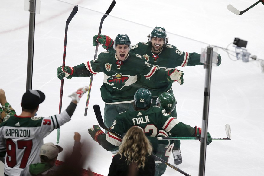 Minnesota Wild left wing Kevin Fiala (22) is congratulated by Joel Eriksson Ek (14) and Mats Zuccarello (36) after scoring a goal against the Vegas Golden Knights during the third period in Game 6 of  ...