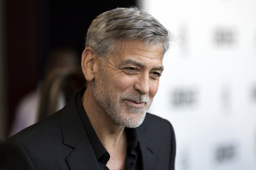 FILE - In this Wednesday, May 15, 2019, file photo, actor George Clooney talks to reporters on arrival at the premiere of the television mini-series &quot;Catch22,&quot; in London. Clooney was honored ...