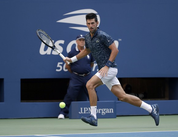 Novak Djokovic, of Serbia, returns a shot to Joao Sousa, of Portugal, during the fourth round of the U.S. Open tennis tournament, Monday, Sept. 3, 2018, in New York. (AP Photo/Carolyn Kaster)