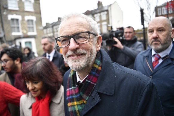 epa08064720 Opposition Labour Party Leader Jeremy Corbyn (C) and his wife Laura Alvez (L) leave after voting at a polling station during the general elections in London, Britain, 12 December 2019. Bri ...