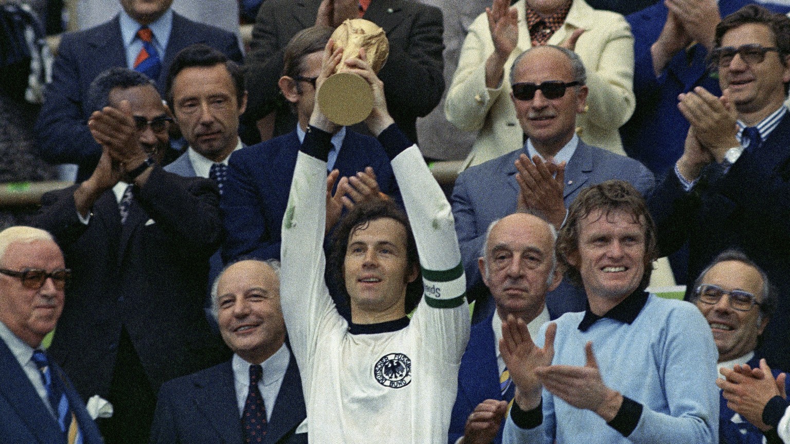 FILE - In this July 7, 1974 file photo, West Germany captain, Franz Beckenbauer, holds up the World Cup trophy after his team defeated the Netherlands by 2-1, in the World Cup soccer final at Munich&# ...