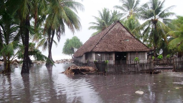 KIRIBATI - MARCH 13: In this handout image provided by Plan International Australia, flood waters surround a house March 13, 2015 on the island of Kiribati. Cyclone Pam is pounding South Pacific islan ...