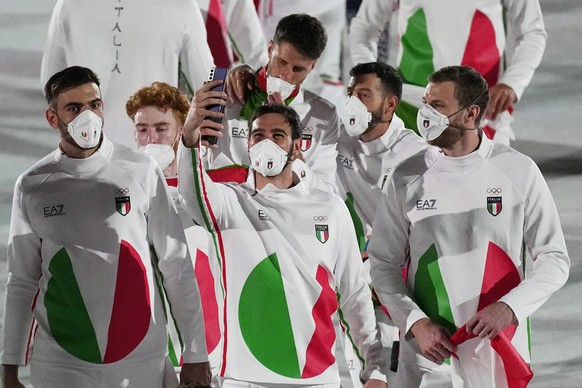 Athletes from Italy march during the opening ceremony in the Olympic Stadium at the 2020 Summer Olympics, Friday, July 23, 2021, in Tokyo, Japan. (AP Photo/David J. Phillip)