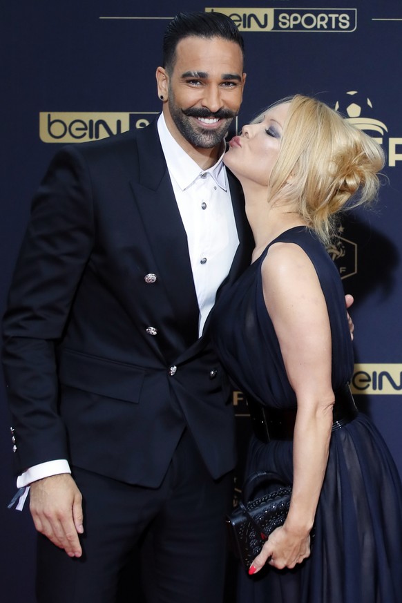 Soccer player Adil Rami and US actress Pamela Anderson pose as they arrive at the UNFP (Union of French Professional Footballers) ceremony, in Paris, France, Sunday, May 19, 2019. (AP Photo/Francois M ...