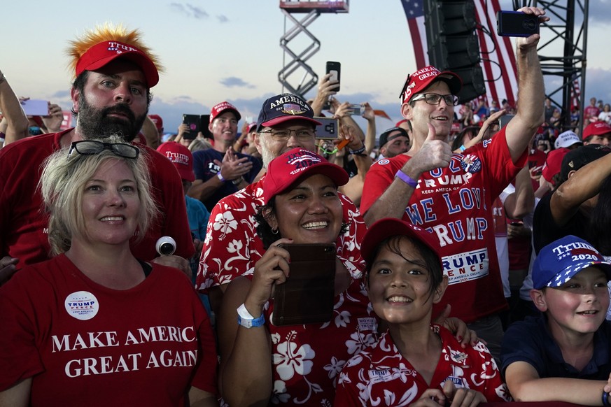 Supporters watch as President Donald Trump speaks during a campaign rally at Orlando Sanford International Airport, Monday, Oct. 12, 2020, in Sanford, Fla. (AP Photo/Evan Vucci)
Donald Trump