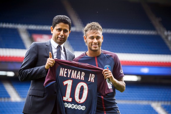 epa06124324 Paris Saint Germain&#039;s chairman and CEO Nasser Al-Khelaif (L) and Brazilian striker Neymar Jr (R) pose for photographs with his new PSG jersey after a press conference at the Parc des  ...