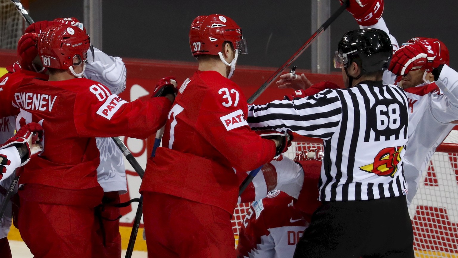 epa09229273 Players (red) of Russia and players (white) of Denmark in action during the IIHF 2021 World Ice Hockey Championships group A match between Russia and Denmark at the Olympic Sports Centre i ...