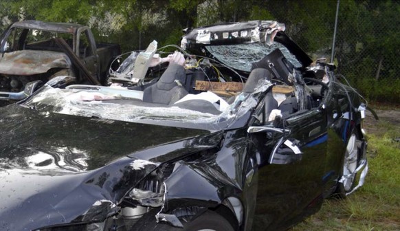 This photo provided by the NTSB via the Florida Highway Patrol shows the Tesla Model S that was being driven by Joshau Brown,who was killed, when the Tesla sedan crashed while in self-driving mode on  ...