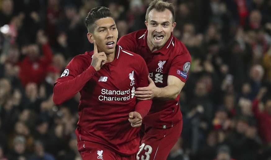 Liverpool forward Roberto Firmino, left, celebrates with teammate Liverpool midfielder Xherdan Shaqiri after he scored the opening goal of the game the Champions League group C soccer match between Li ...