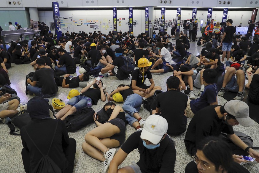 Protesters stage a sit-in protest at the Hong Kong International Airport, Monday, Aug. 12, 2019. One of the world&#039;s busiest airports canceled all flights after thousands of Hong Kong pro-democrac ...