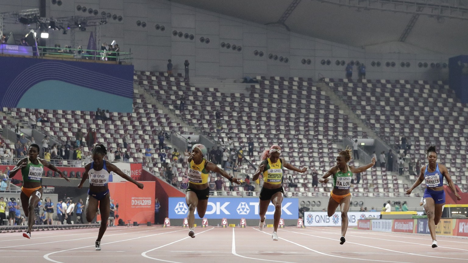 Shelly-Ann Fraser-Pryce, of Jamaica, third left, wins the gold medal in the women&#039;s 100 meter final ahead of Dina Asher-Smith, of Great Britain, second left, silver, and Marie-Josée Ta Lou, of Th ...