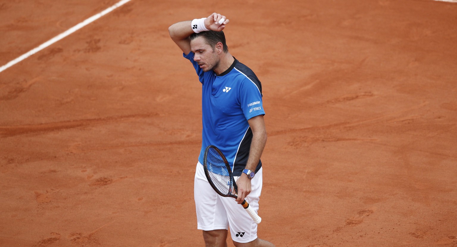 Switzerland&#039;s Stan Wawrinka wipes the sweat off his face in his first round match against Spain&#039;s Guillermo Garcia-Lopez at the French Open tennis tournament at the Roland Garros stadium in  ...
