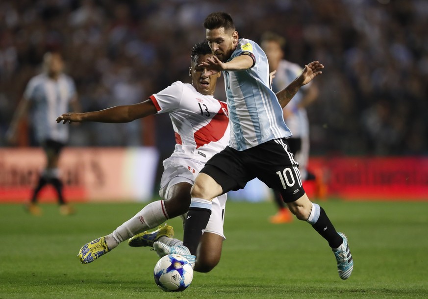 epa06247241 Lionel Messi (R) of Argentina vies for the ball with Renato Tapia (L) of Peru during the 2018 FIFA World Cup Conmebol qualification match between Argentina and Peru at La Bombonera Stadium ...
