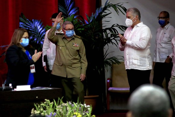 Raul Castro, first secretary of the Communist Party and former president, waves to members at the VIII Congress of the Communist Party of Cuba&#039;s opening session, as Cuban President Miguel Diaz-Ca ...