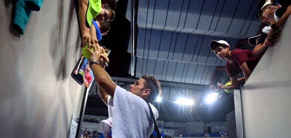 epa05721606 Stan Wawrinka of Switzerland signs autographs after winning against Martin Klizan of Slovakia during their Men&#039;s Singles first round match at the Australian Open Grand Slam tennis tou ...