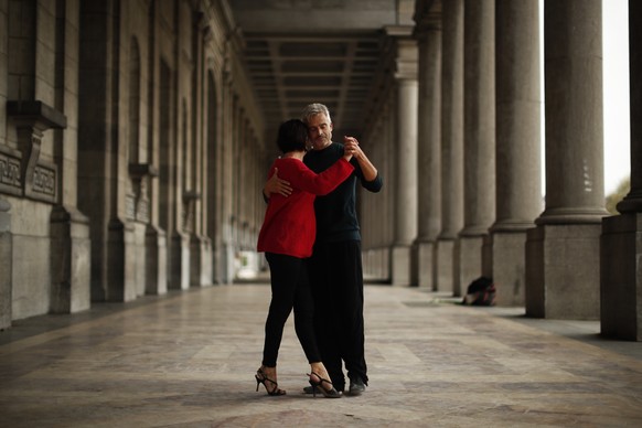 A couple dances the tango on the arcade of the Royal Military museum at Cinquantenaire park in Brussels, Wednesday, Nov. 11, 2020. This autumn, Belgium was the European country with the highest number ...