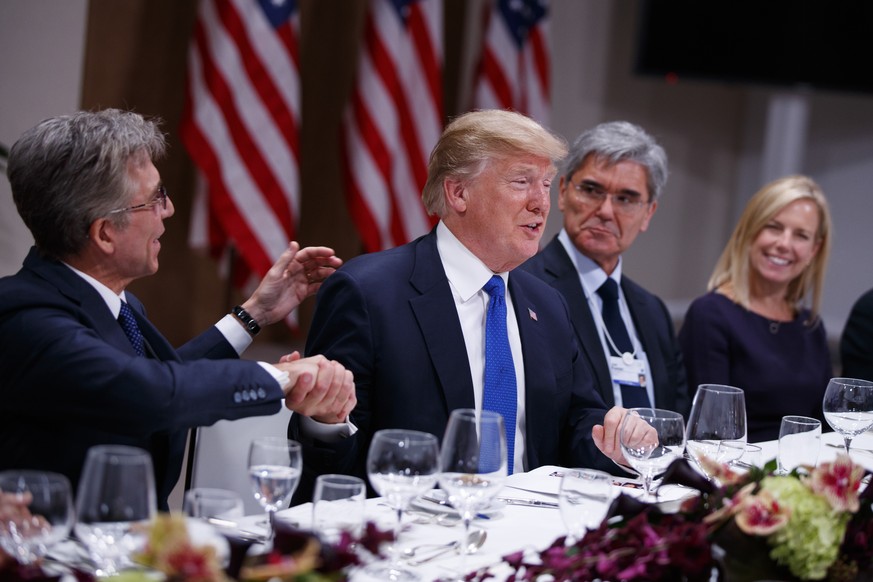 President Donald Trump listens during a dinner with European business leaders at the World Economic Forum, Thursday, Jan. 25, 2018, in Davos. From left, SAP CEO Bill McDermott, Trump, CEO of Seimens J ...