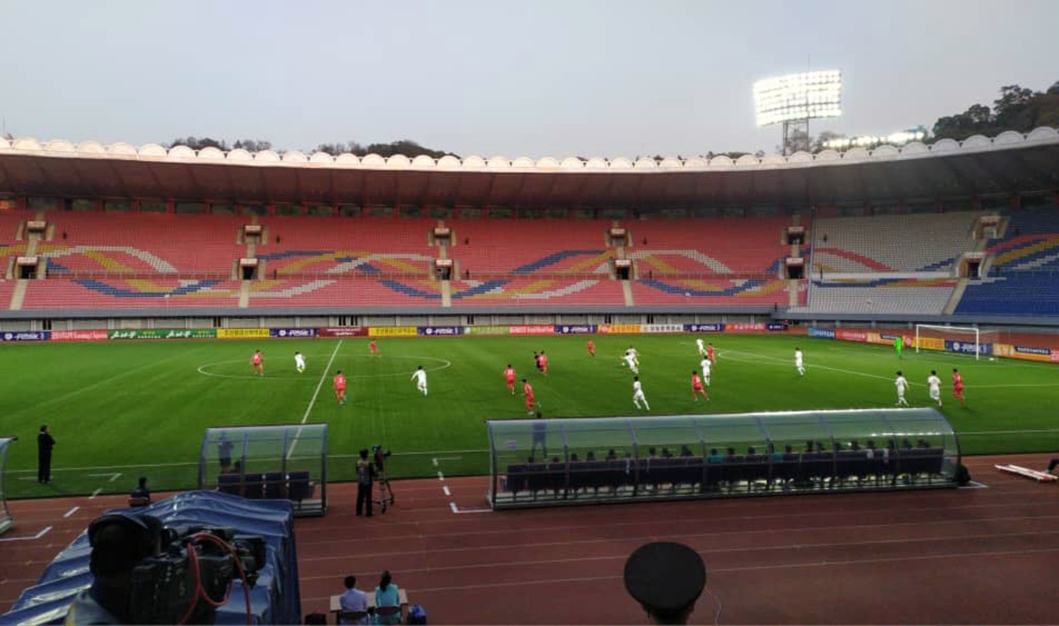 In this photo provided by the Korea Football Association, South and North Korean, wearing red uniforms, players play during their Asian zone Group H qualifying soccer match for the 2022 World Cup at K ...
