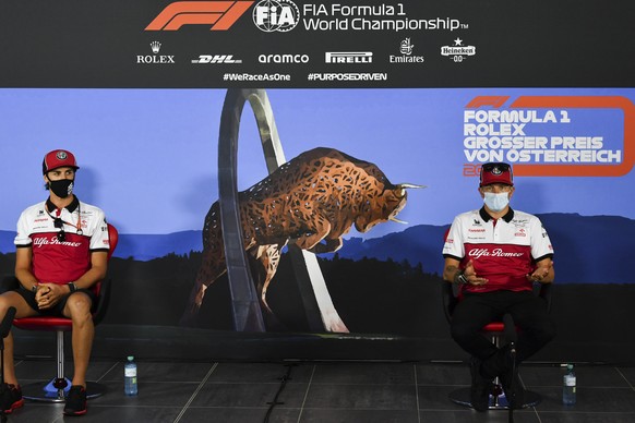 Alfa Romeo drivers Antonio Giovinazzi of Italy, left and Kimi Raikkonen of Finland speak during drivers news conference the at the Red Bull Ring racetrack in Spielberg in Spielberg, Austria, Thursday, ...