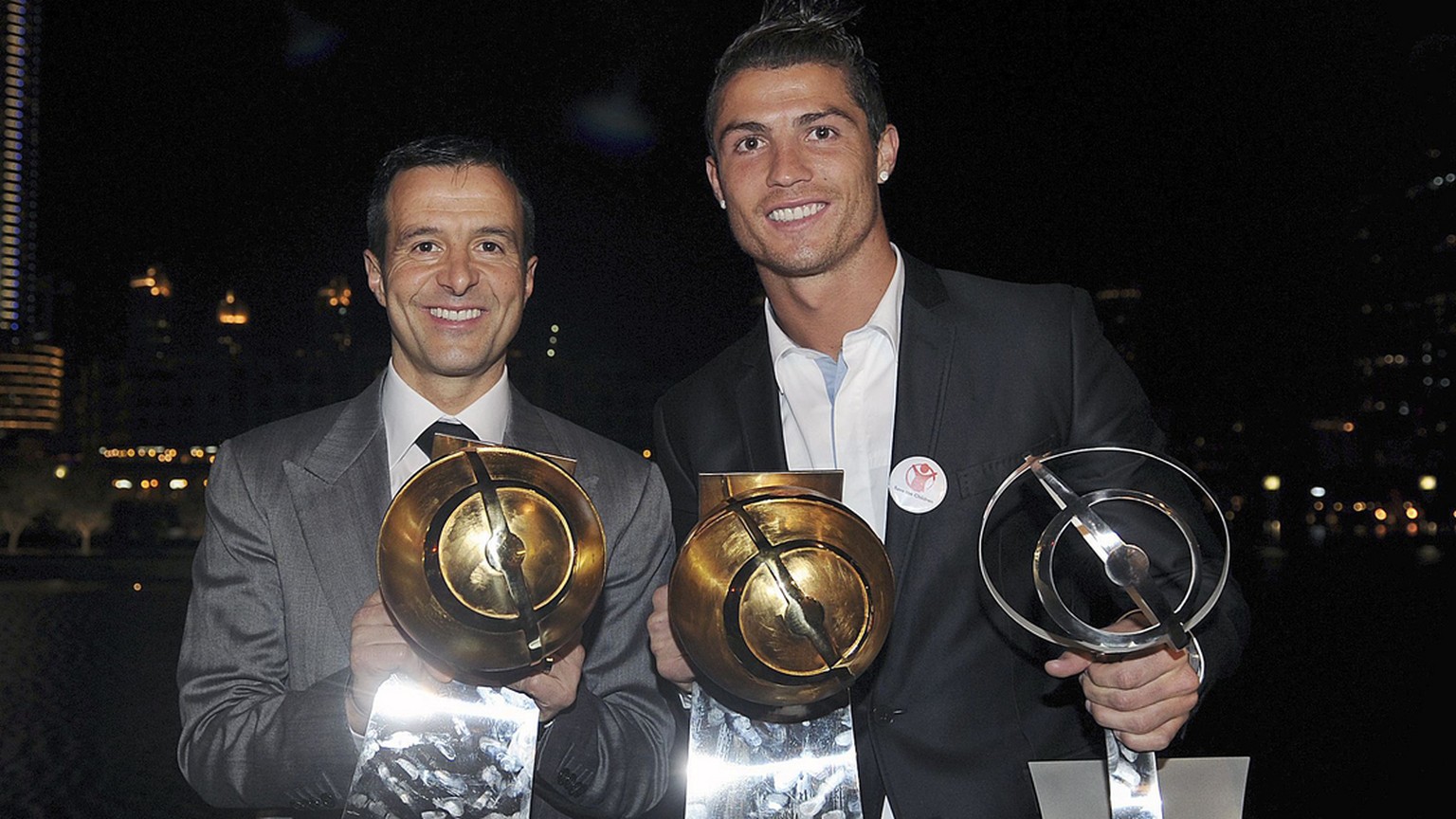 epa03044492 Real Madrid soccer player, Portuguese Cristiano Ronaldo (R), and his manager Jorge Mendes (L), pose with the trophies won during the Globe Soccer Awards ceremony held at Dubai, UAE, 28 Dec ...